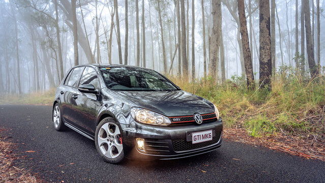 New South Whales, Australia - Feb 14, 2023: Volkswagen Golf GTI MKVI parked in a foggy forest