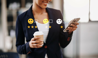 Customer service evaluation concept. African Businesswoman pressing face smile emoticon show on virtual screen at tablet and smartphone in office.