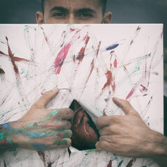 Man with torn canvas and the heart exposed.
