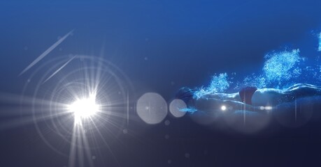 Composition of male swimmer swimming under water with copy space and glowing light