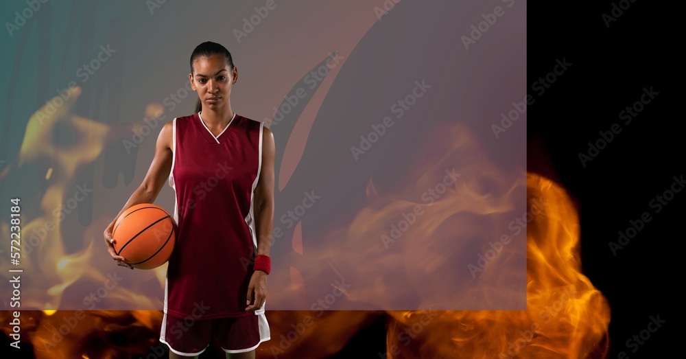 Sticker Composition of female basketball player standing holding ball, over flames and grey background