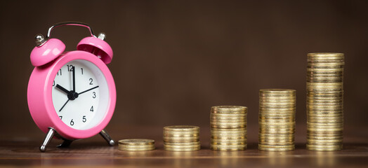 Financial and business planning or success. Save money for pension, retirement. Golden coins with alarm clock banner.