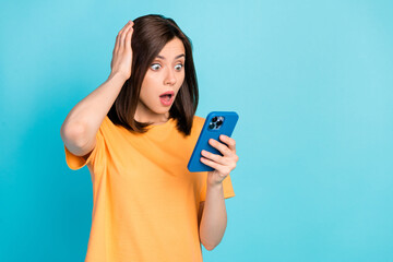 Portrait of impressed speechless lady hand touch head open mouth stare telephone isolated on blue color background