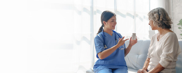 Young asian caretaker with 60s asia elderly woman consulting and encourage, take a history and recommend the right treatment, recommend taking painkillers and cure cancer