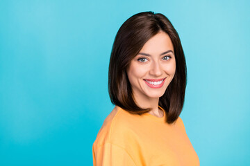 Fototapeta premium Portrait of gorgeous positive toothy beaming girl with straight hairstyle yellow t-shirt bright smiling isolated on blue color background