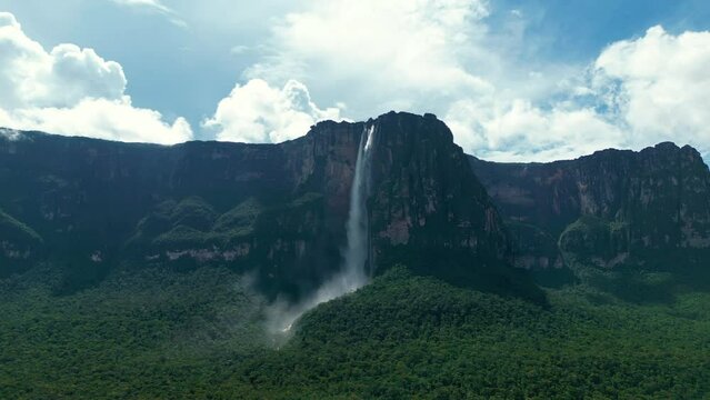 Aerial view from far of Angel Falls waterfall. A huge flow of water falls from the mountain. The tallest uninterrupted waterfall in the world. Canaima National Park, Venezuela.
