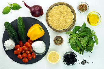 Orzo pasta, basil, cucumbers, cherry tomatoes, olives, bell peppers, purple onions, olive oil, garlic, lemon.