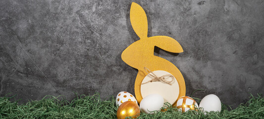 Happy Easter background banner holiday greeting card - Golden Easter bunny and easter eggs on green...