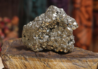 Pyrite Specimen on Raw Tigers Eye Rock With Dried Herbs in Background