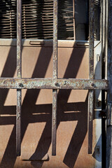 Fototapeta na wymiar aged and rusty irons of an old window 