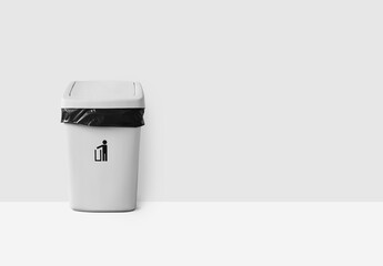 White trash can with lid on white background