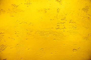 Artificial Gold background and texture on cement make from color paint for look like real gold. Gold foil leaf dirty abstract background texture distress scratch and gradients shadow in Gold glitter