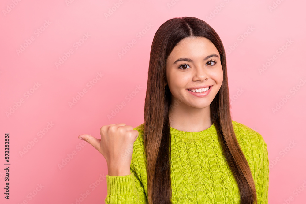 Wall mural Photo of cheerful nice girl beaming smile indicate thumb finger empty space isolated on pink color background