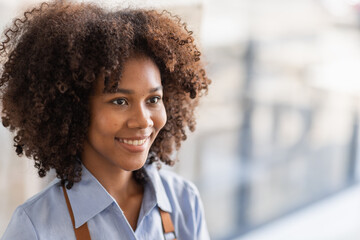 Successful african woman in apron standing coffee shop door. Happy small business owner holding tablet and working. Smiling portrait of SME entrepreneur seller business standing with copy space.