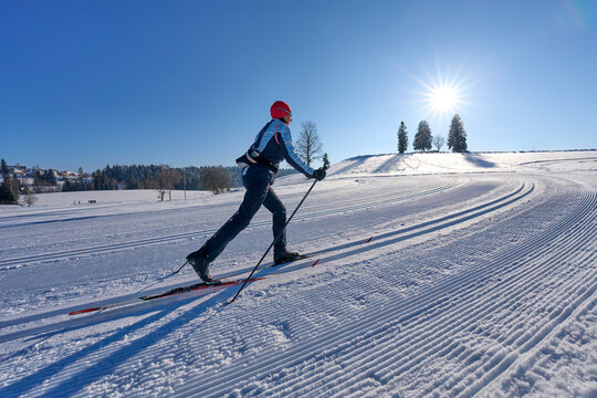 nice, active woman cross country skiing in the Bregenz Forest Mountains near Sulzberg, Vorarlberg, Austria    