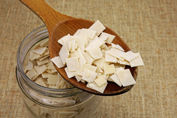 homemade raw noodles in wooden spoon
