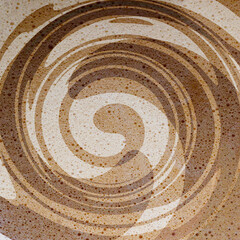 A creamy coffee closeup abstract with swirls and bubbles