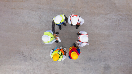 Aerial top view of architect and engineer discussing building plan at construction building site in warehouse factory. Precast concrete manufacturing products on prefabricated house factory	