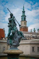 Neptune's fountain on the background of the bell tower in Poznań. - obrazy, fototapety, plakaty