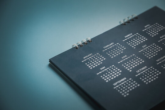 Embroidered red pins on a calendar event Planner calendar,clock to set timetable organize schedule,planning for business meeting or travel planning concept.