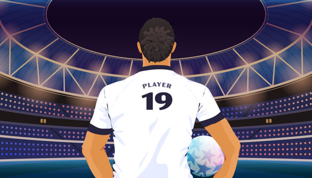 Rear view of a soccer player holding a football in a stadium 