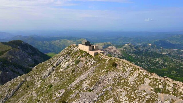 This stock video showcases the breathtaking aerial footage of the Njegos Mausoleum located at the top of the Jezerski peak in Montenegro. The mausoleum is a stunning architectural masterpiece