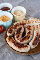Grilled sausages with sauce and vegetables. Summer rest concept