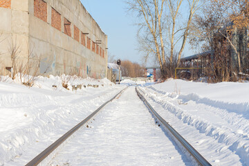 Railway Road tracks adjacent to abandoned houses among drifts and snow.selective focus, copy space
