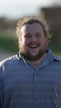 One Overweight Young Happy Man Real Life Laugh And Smile. Portrait Of A Casual Male Caucasian Person Laughing Outdoors In Sunlight