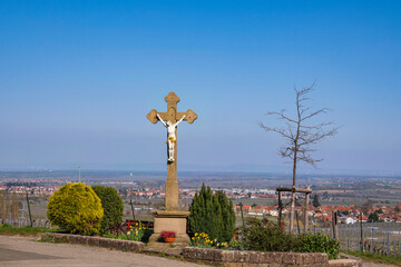 View of a crucifix with floral decorations in a small town in Rhineland-Palatinate/Germany