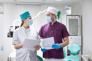 Medical team of dentists doctors examining the X-ray panoramic film of a patient dentistry clinic