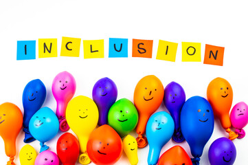 Balloons of different colors on a white surface, and text 