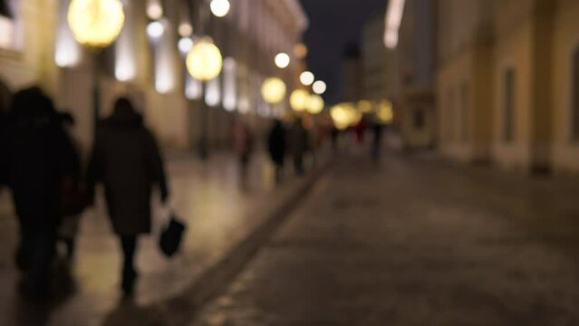 people walking down the street in the evening video out of focus