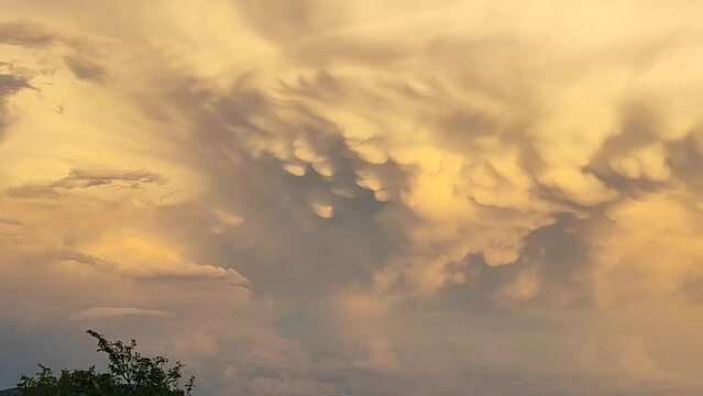 Mesmerizing clouds in the sky after a summer storm, real time, close up pan.