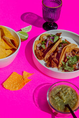 Esthetic flash food photography of Mexican taco table setting with shadows on bright color background