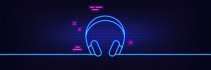 Neon light glow effect. Headphones line icon. Music listening device sign. DJ or Audio symbol. 3d line neon glow icon. Brick wall banner. Headphones outline. Vector
