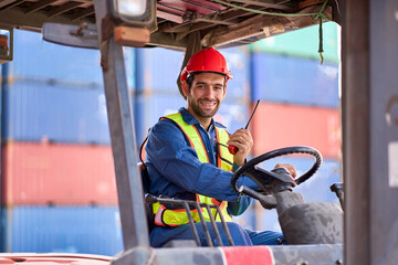 Smart Foreman use walkie talkie for communicate with team whe he ride a folklift in container box site