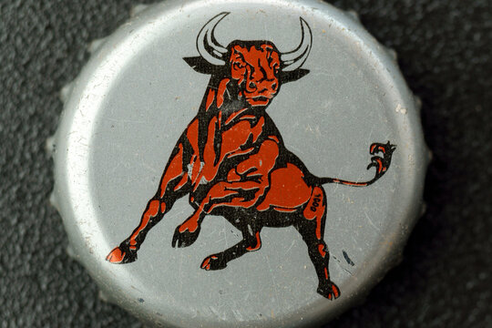 Tyumen, Russia-February 15, 2023: Lid of a glass bottle with the image of a bull, red bull old logo. The most popular energy drink in the world.