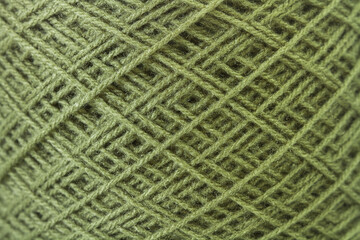 Primer plano macro de un hilo de lana verde. Vista de frente y de cerca