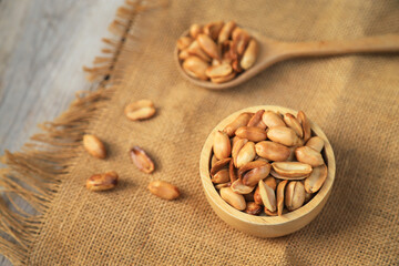 Yellow roasted groundnut on sack for healthy food eating or being in cooking ingredient. selective focus.