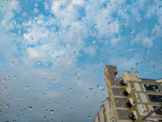 Glass rain drops, condo buildings, cloudy, blue sky, weather forecast, Meteorological Department
