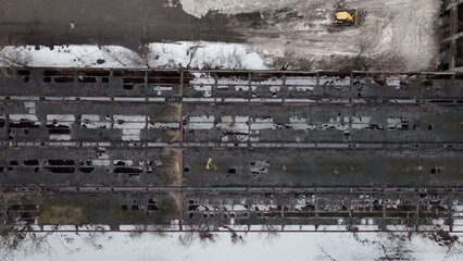 Buffalo, NY city workers clear streets after snow storm by piling snow beside old train depot