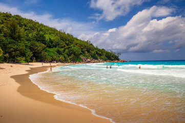 Anse Georgette beach with tourists at the Praslin island, Seychelles