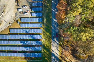 Aerial view of big sustainable electric power plant with many rows of solar photovoltaic panels for producing clean electrical energy. Renewable electricity with zero emission concept