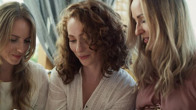 Group of female friends looking an ultrasound scan result. Shot with RED helium camera in 8K.  