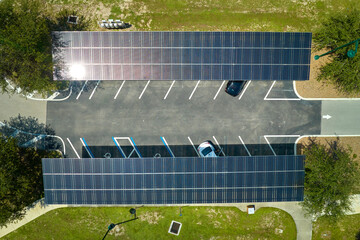 Aerial view of solar panels installed as shade roof over parking lot for parked cars for effective...