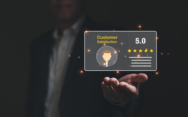 Selective focus at finger of business man while point finger to choose feedback on excellent customer service with five star score with smile. Service evaluation concept with futuristic icon