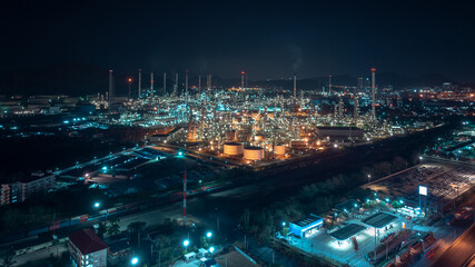 Fototapeta premium industrial area production plant or refinery crude oil and gas for transportatioon and export, aerial photography at night scene from drone,