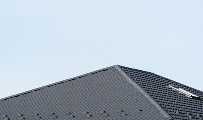 Modern roof made of metal. Black metal tile roof