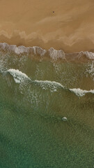 Fototapeta na wymiar beautiful sandy beach and turquoise sea with light surf